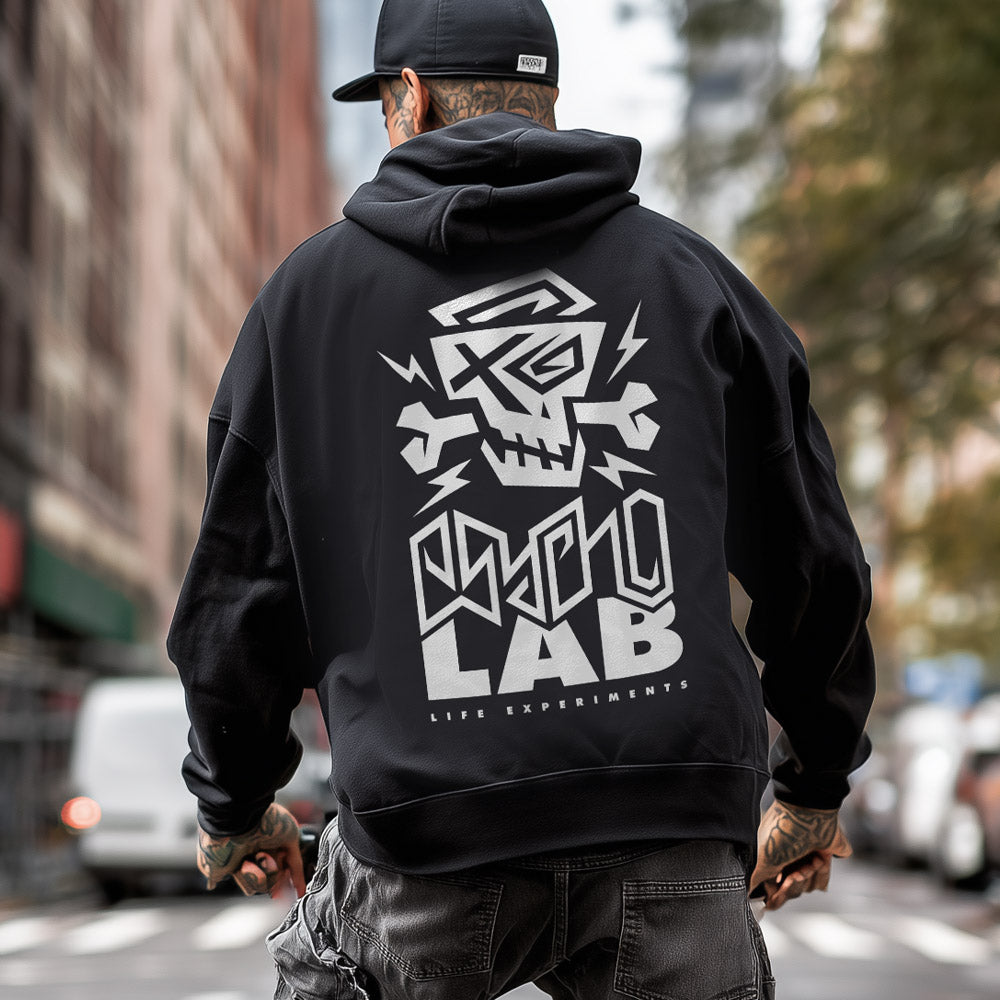 Mann trägt den Hoodie Back Logo Black von PsychoLab, sichtbar mit auffälligem Logo auf der Rückseite, während er durch die Stadt läuft. Ideal für urbane Mode und Stilbewusstsein. psycholab
